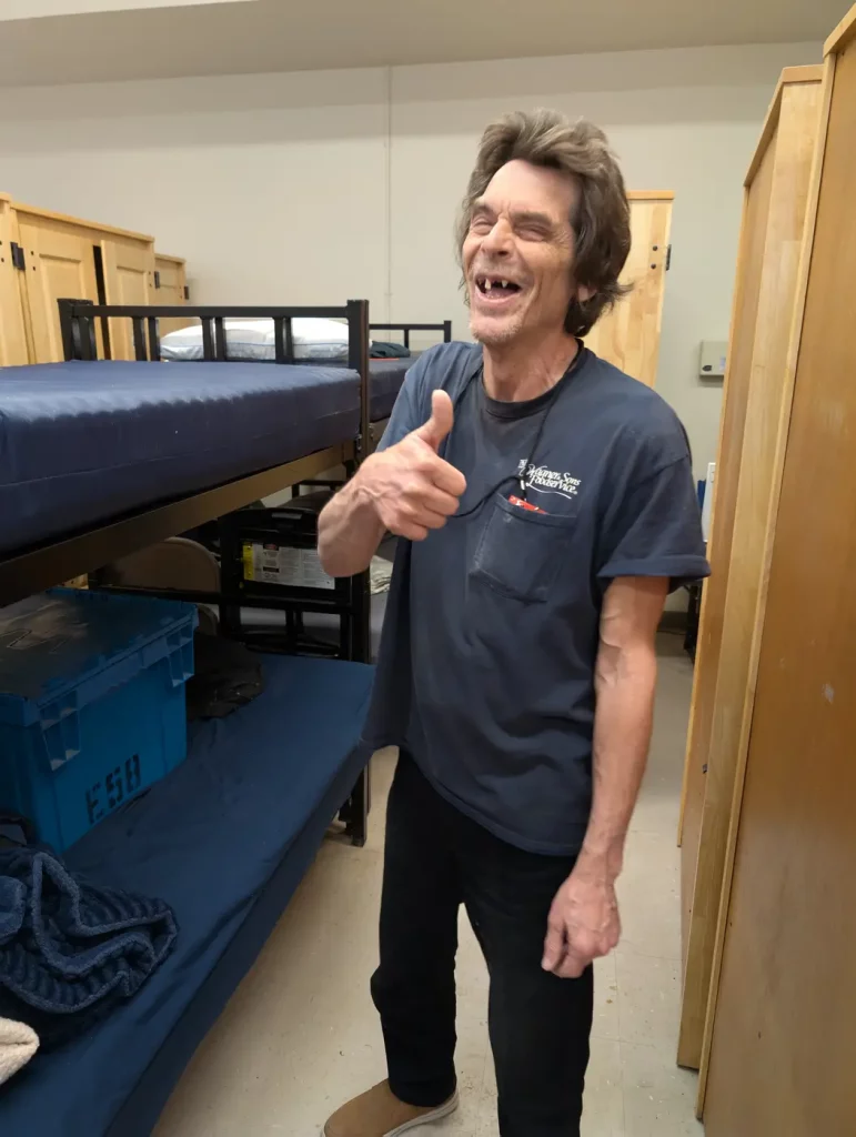 A resident setting up his room in the dorms