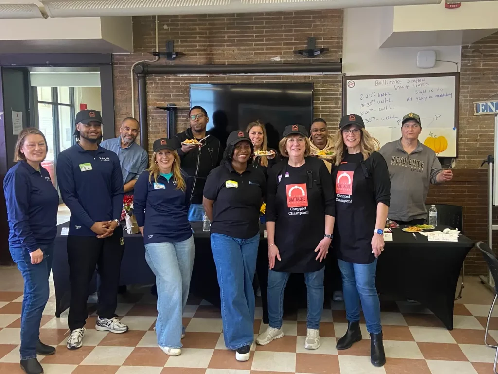Corporate volunteers cooking together in our kitchen