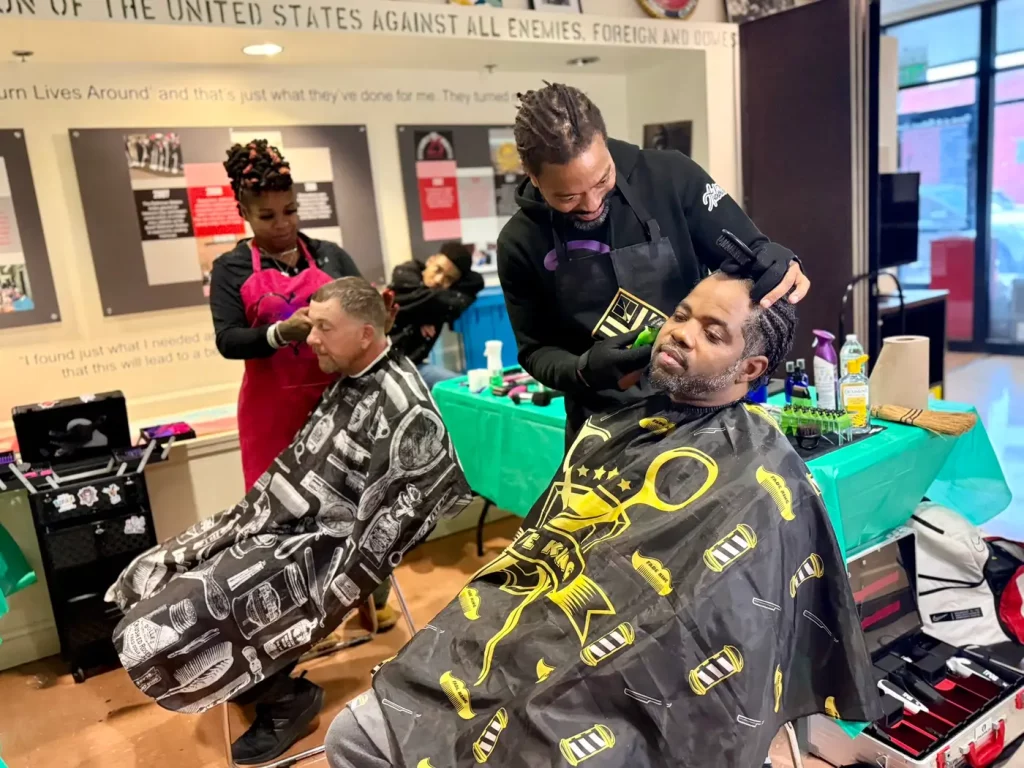 A resident receiving a haircut on site