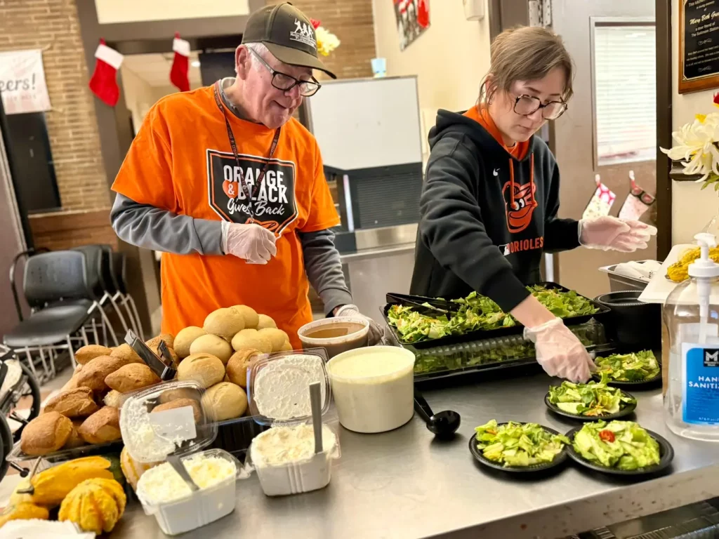 Volunteers preparing donated food in The Baltimore Station kitchen