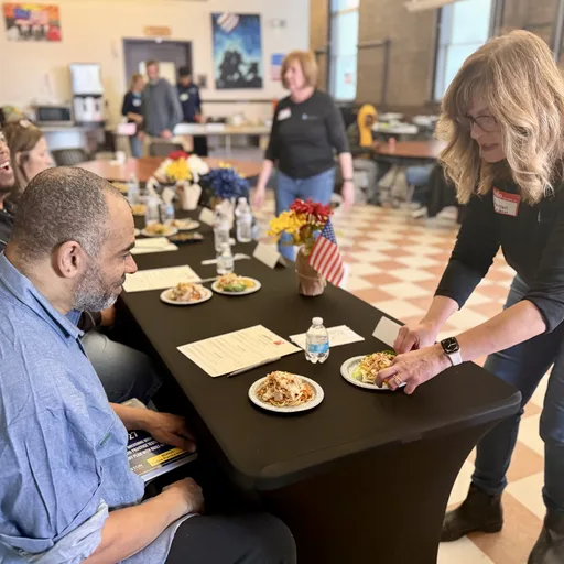Staff and volunteers serving a meal at The Baltimore Station