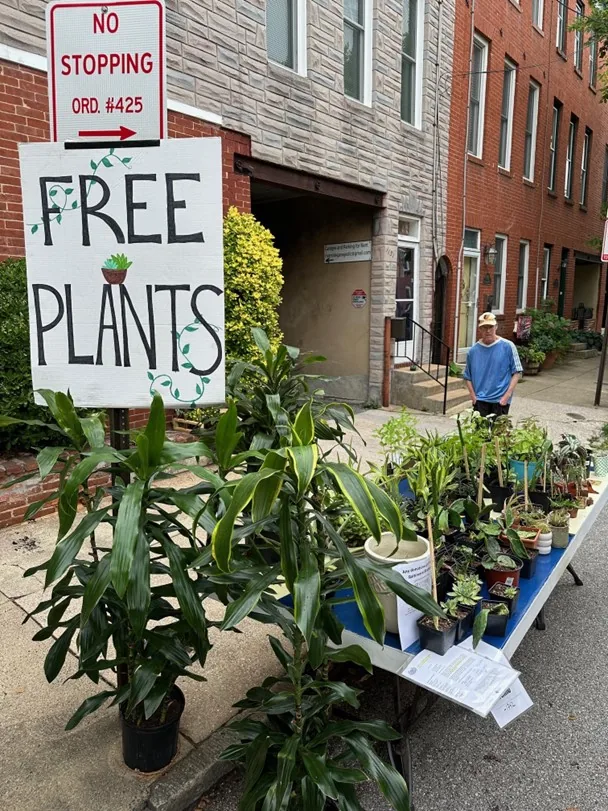A “Free Plants” sign beside Pete’s plant giveaway on a Baltimore street