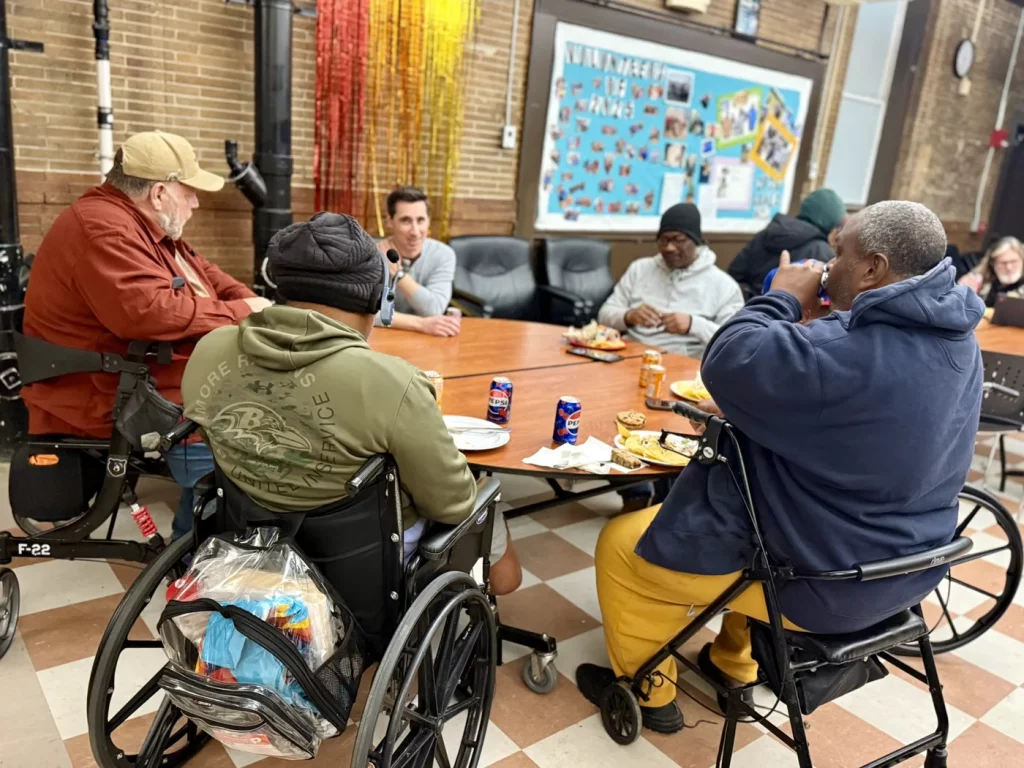 Residents and volunteers sharing a meal at The Baltimore Station